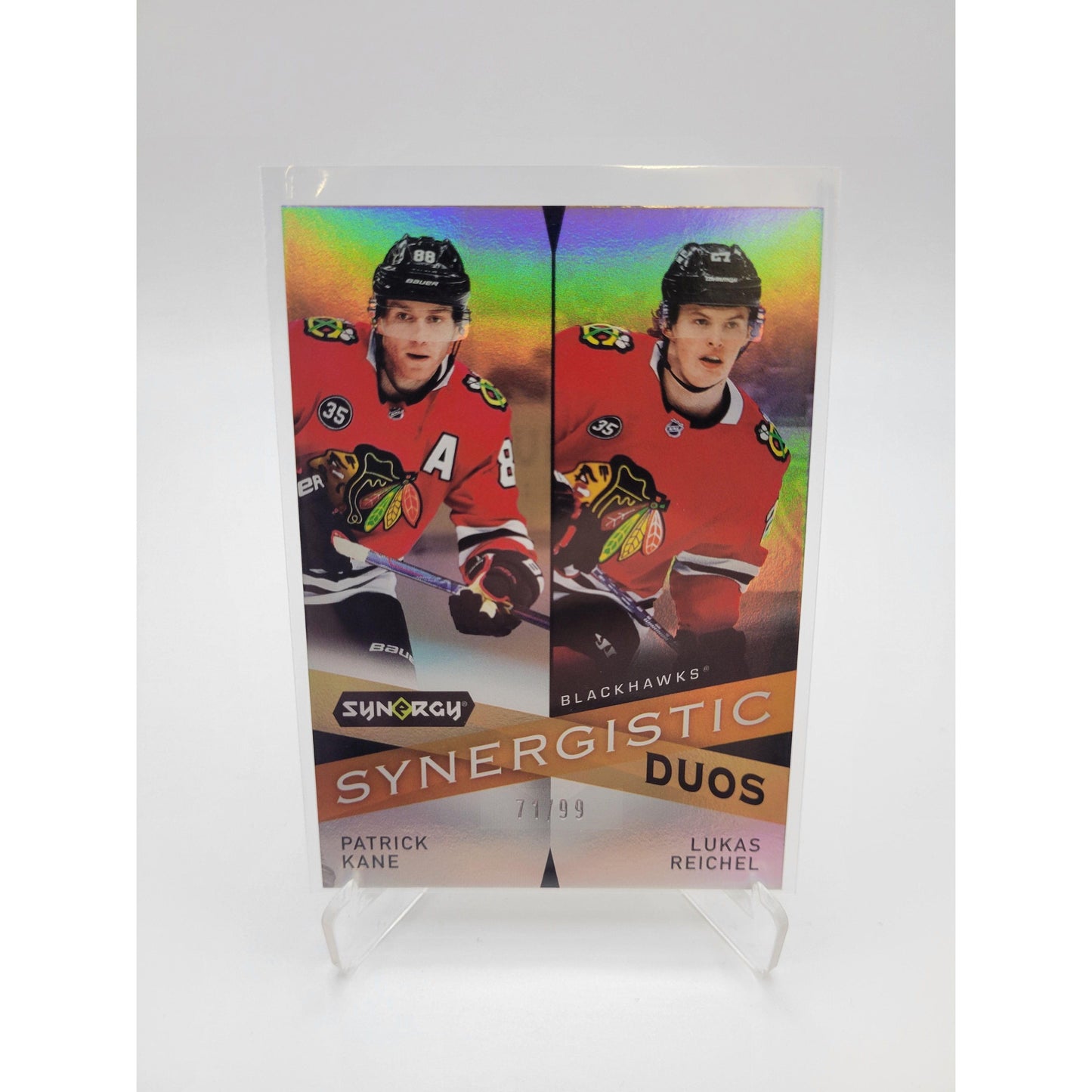 Patrick Kane / Lukas Reichel - 2022-23 Synergy - Synergistic Duos Star-Rookie Gold #SD-12 (SN99) - Geek & Co. 2.0